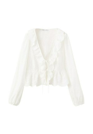 Blouse blanche à manches longues avec un décolleté en V profond, bordure à volants le long de l'encolure et de l'ourlet, et une fermeture à nouer à l'avant.