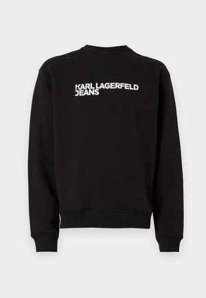 Juoda palaidinė su apvalia iškirpte ir įribiuotais rankogaliais. Priekyje yra baltas tekstas "KARL LAGERFELD JEANS". Minkšta medžiaga.