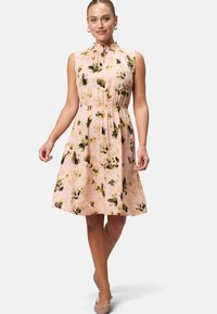 Floral-print dress in soft pink with green and yellow accents. Features a high neckline, sleeveless design, and gathered waist.