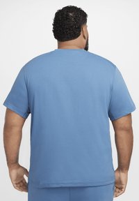 Light blue short-sleeve t-shirt made of soft cotton, featuring a crew neckline and a relaxed fit, with visible stitching along the seams.