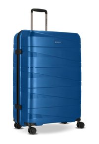 Gran maleta rígida azul con cuatro ruedas giratorias y un mango telescópico extendido.