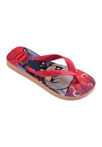 Tongs en caoutchouc rouge avec un design graphique représentant un personnage sur une semelle texturée et une base rose. Accentué par de fines lanières rouges.