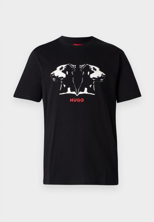 Black cotton t-shirt featuring a white graphic of two dog heads and red "HUGO" text below. Short sleeves and crew neck design.