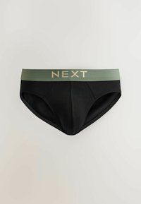 Caleçons pour hommes noirs avec une large ceinture olive portant le mot "NEXT" en grandes lettres beiges.