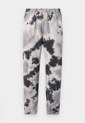 Melnbaltas sasietās krāsas sporta bikses ar elastīgu vidukli un aprocēm, attēlotas pret vienkāršu gaišu fonu.