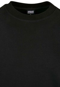 Felpa nera a girocollo realizzata in morbido cotone. Presenta un colletto a coste e un'etichetta che indica la taglia "M". Design minimalista.