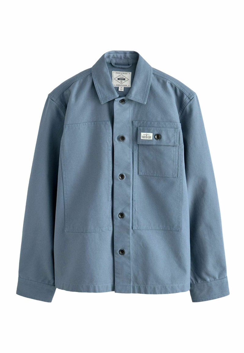 Blue long-sleeve button-up shirt with collar and chest pocket featuring a button and sewn label on white background.