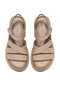 Sandali in pelle beige con cinturini incrociati e una cinghia alla caviglia con velcro. Presentano una soletta imbottita e una suola leggera e testurizzata.