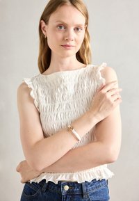 Zapestnica - gold-coloured