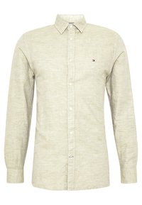 Béžová košile s dlouhým rukávem a knoflíky, s malým vyšitým logem na levé části hrudi a klasickým límečkem.