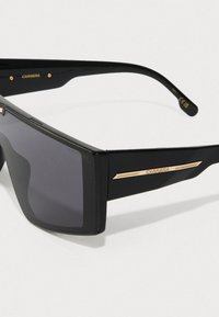 Sorte rektangulære solbriller med mørke linser, med gullakenter på templene. Rammen har matt finish og en slank design.