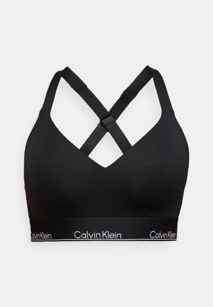 Svart bralette med V-halsdesign, kryssryggstropper og elastisk logobånd. Laget av et glatt, stretchbart stoff.