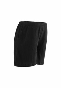 Pantaloni corti neri realizzati in tessuto testurizzato, dotati di una cintura elastica e tasche laterali; il design offre una vestibilità rilassata e uno stile casual.