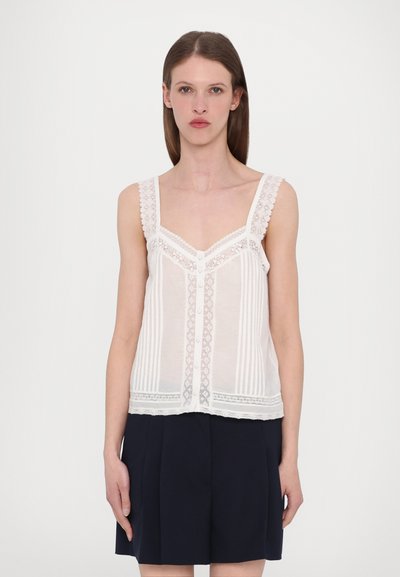 Top crème sans manches avec des accents en dentelle, des détails de boutons et des rayures verticales. Tissu léger avec une texture légèrement transparente. Idéal pour le superposition.