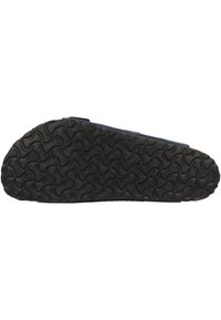 Suola in gomma nera e texturizzata con un motivo a onde, che indica un design antiscivolo. La tomaia sembra essere di tessuto blu navy con una silhouette semplice.