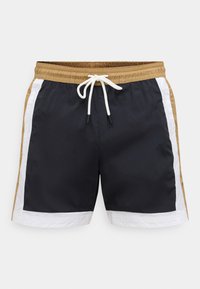 Pánske plavecké kraťasy v námorníckej modrej farbe s béžovými a bielymi bočnými panelmi. Majú elastický pás so sťahovacou šnúrkou a hladkú textúru látky.