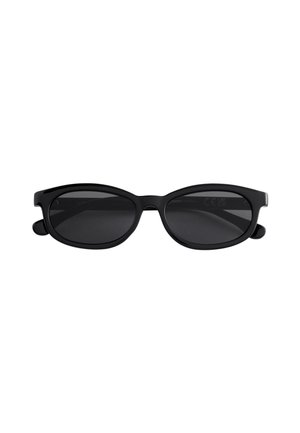 Lunettes de soleil ovales noires avec une monture épaisse en plastique et des verres teintés foncés, présentées sur un fond blanc.