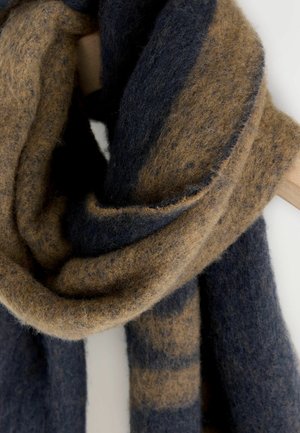 Wool scarf in dark navy and light brown, featuring a soft, fuzzy texture with alternating stripes and a draped, cozy appearance.
