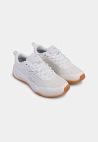 White athletic shoes with mesh upper, rounded toe, and rubber outsole featuring a flexible design and orange accents on the sole.