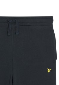 Marineblaue Jogginghosen aus weichem Stoff, mit einem Kordelzugbund und einem kleinen gelben gestickten Logo auf der linken unteren Seite.