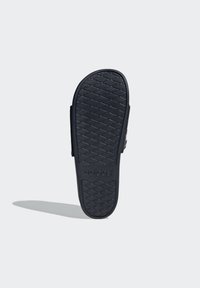 Black Adidas slide sandal with a textured rubber sole, featuring a zigzag pattern and embossed logo for grip and comfort.