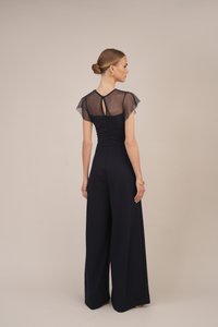 Marine jumpsuit med en tettsittende bodice og vide ben. Gjennomsiktige flatterende ermer og en nøkkelhull detalj bak. Glatt tekstur.