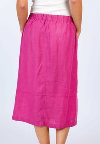 A mid-length, pink linen skirt with an elastic waistband, featuring a smooth texture and simple stitching along the hem and seams.