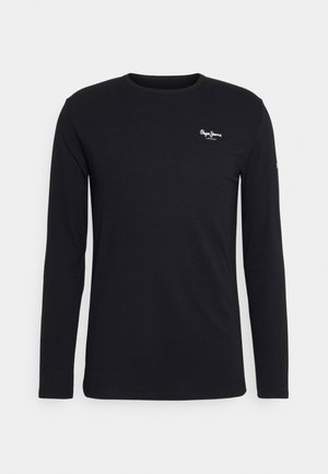 Svart långärmad t-shirt i mjuk bomull. Har en liten vit logotyp på bröstet och en rund halsringning. Enkel och figurnära design.