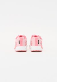 Pink athletic shoes with a mesh upper, white sole, and grey accents. Features adjustable heel tab and textured rubber outsole.
