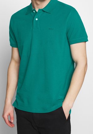 Türkiser Baumwoll-Polo-Shirt mit Kragen, kurzen Ärmeln und einem dezenten Logodetail. Der Stoff hat eine glatte Textur und eine klassische Passform.