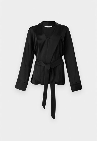 Black satin wrap top with long sleeves, a deep V-neck, and a self-tie belt at the waist. Features smooth texture and relaxed fit.