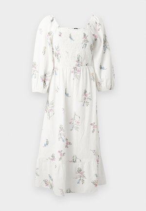 Robe midi blanche avec manches longues bouffantes, encolure carrée smockée et délicat imprimé floral rose et bleu.