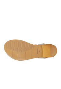 Suola in gomma marrone con righe orizzontali e branding. Il design presenta una cinghia di colore chiaro nella parte superiore. Texture liscia su tutta la superficie.