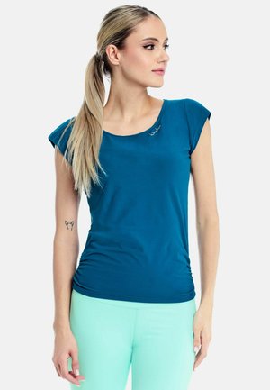 Teal short-sleeve fitted top, smooth fabric with a scoop neck and subtle logo detail. Paired with light mint green leggings.