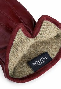 Burgunderfarbene Lederhandschuhe mit einem mit Wolle gefütterten Innenraum, die eine weiche Textur und ein geprägtes Etikett mit der Aufschrift "ROECKL MÜNCHEN" aufweisen.