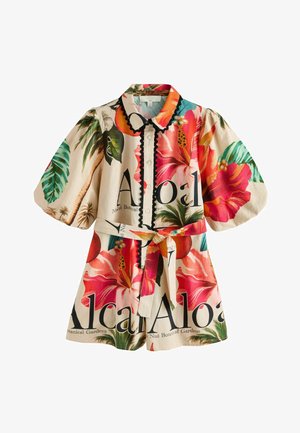 Kort ærmet romper til børn med tropisk blomsterprint, knapper foran, sort kant og matchende taljebånd.