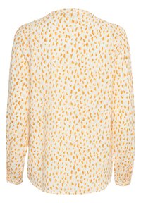 Blouse à manches longues en tissu léger, avec une base blanche ornée de taches irrégulières orange et jaunes, col rond et coupe ample.