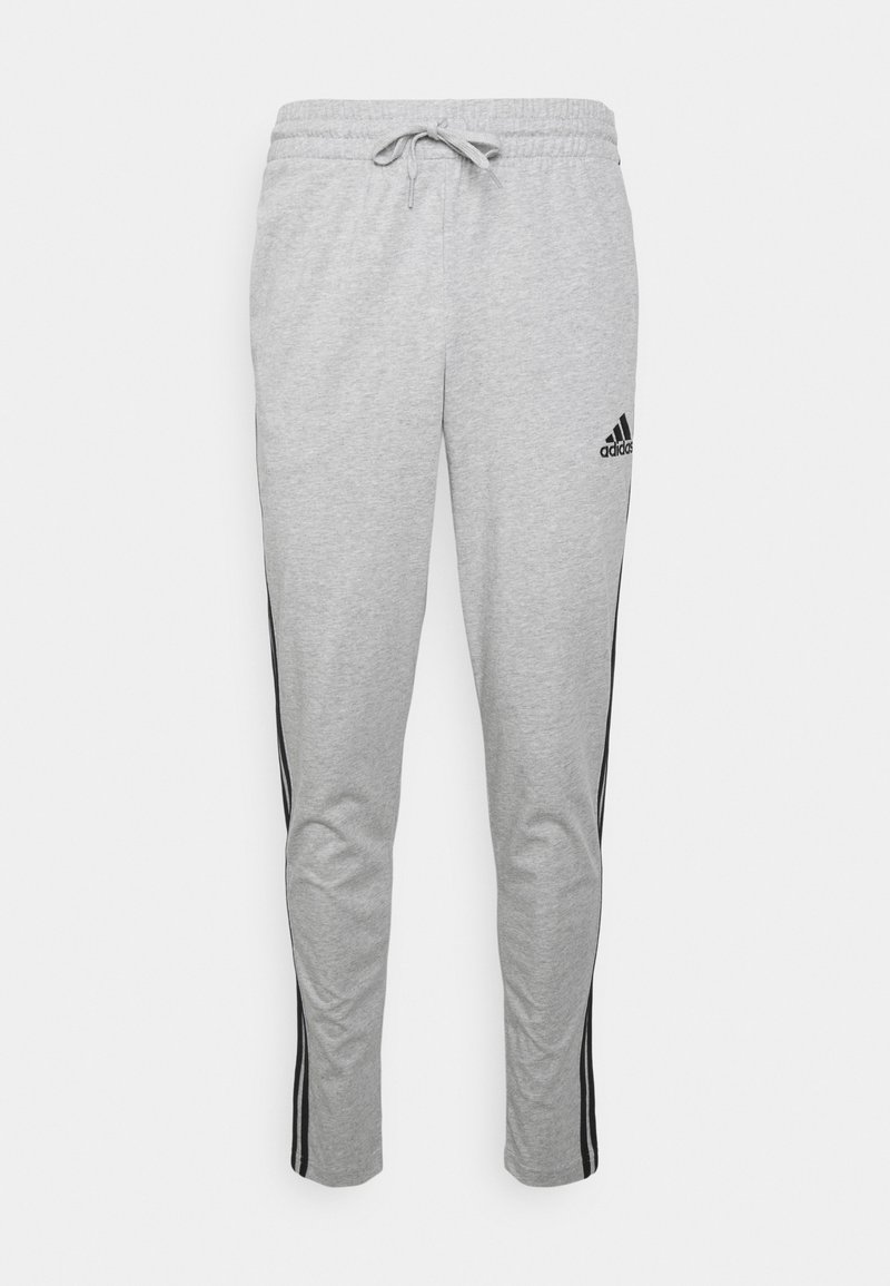 Szare dresy z elastycznym paskiem z troczkiem, czarnymi bocznymi paskami i logo Adidas na lewej udzie.