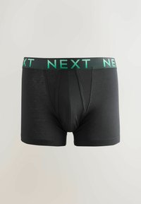 Bóxer negro hecho de tejido suave, con una cinturilla con el logo verde "NEXT" y un ajuste cómodo con una apertura frontal.