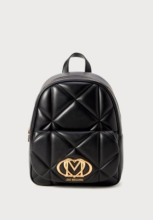 Black quilted backpack made of synthetic material, featuring a gold logo accent at the front and a rounded shape with a top handle.