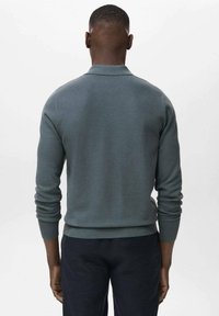 Sweater in a muted teal color, crafted from a textured knit. Fitted design with long sleeves and ribbed cuffs and hem.