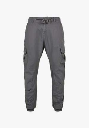 Pelēki kravas bikses, kas izgatavotas no viegla auduma, ar elastīgu jostu ar auklu, vairākiem sānu kabatām un sašaurinātiem piedurkņu galiem.