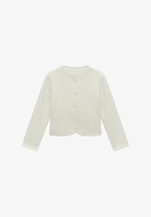 Valkoinen kudottu takki, jossa on pyöreä kaula-aukko, pitkät hihat, viiden napin suljenta ja kaksi etutaskua. Kuosisessa kankaassa on hillitty kuvio.