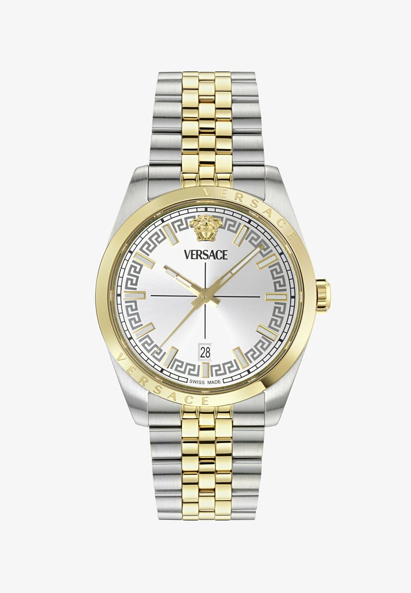 Montre-bracelet Versace avec bracelet en métal doré et argenté, cadran blanc, index dorés, logo Méduse, guichet de date et motif géométrique autour du cadran.
