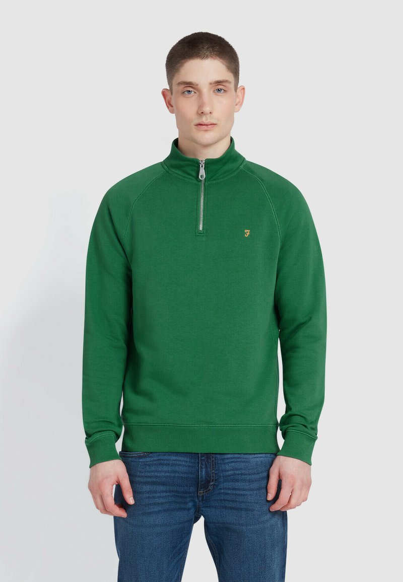 Green pullover sweatshirt with a high zip collar, ribbed cuffs, and hem. Features a small logo on the chest. Made of soft, textured fabric.