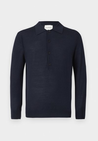 Maglione polo a maniche lunghe blu navy con patta di bottoni e polsini a coste, presentato su uno sfondo bianco.