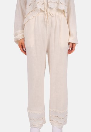Pantalons légers de couleur crème en tissu texturé, dotés d'une taille élastique et d'une délicate dentelle au niveau de l'ourlet.