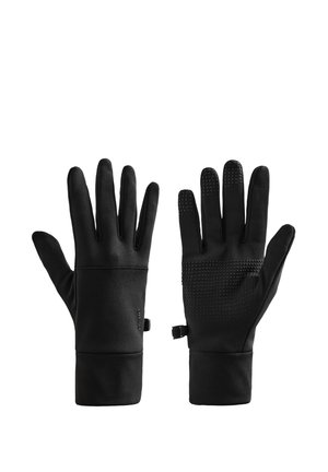 Paire de gants noirs avec des points d'adhérence sur la paume et les bouts des doigts, des poignets prolongés et de petites attaches latérales sur fond blanc.