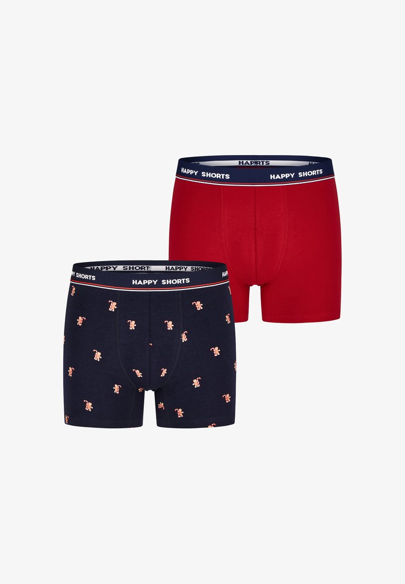 Twee paar heren boxershorts. Leveren één in effen rood, de andere in marineblauw met kleine herhaalde peperkoekmannetjespatronen. Beide hebben een zwarte tailleband.