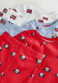 Four children's tops in white, blue, and red, featuring playful prints of fire trucks and police cars; made of soft fabric, with ribbed necklines.